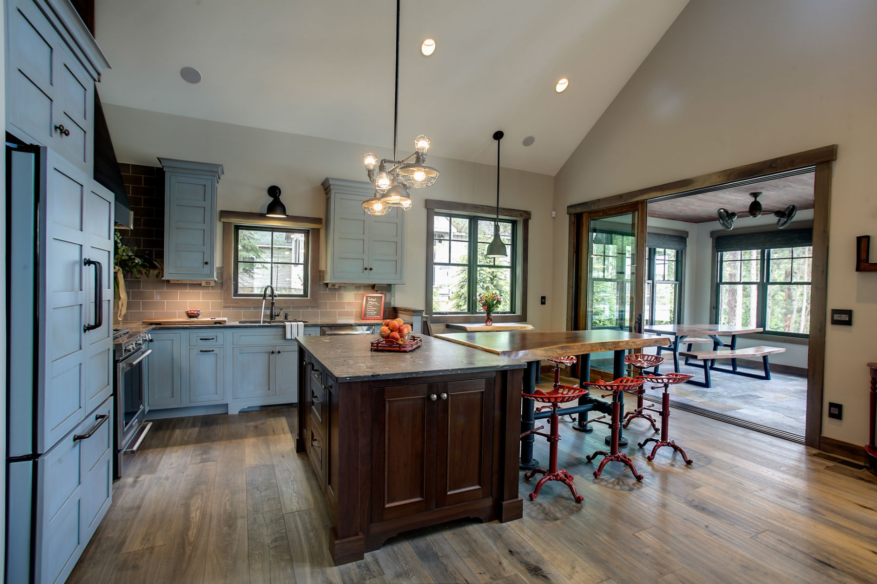 The Cottage's bright kitchen and dining area opening onto a four-season screened porch