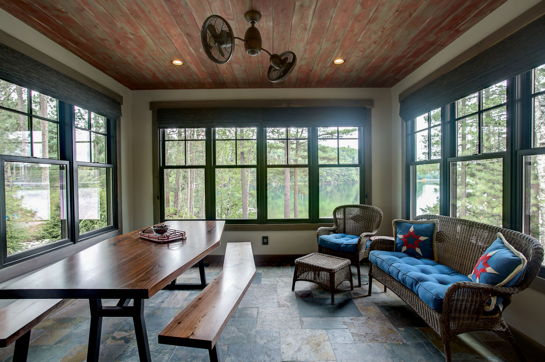 A four-season screened porch set up for a team retreat, overlooking the lake